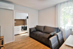 a living room with a couch and a kitchen at House Stavrevi in Varna City