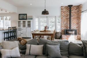 a living room with a couch with a dog laying on it at Drift House in Quindalup