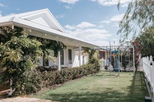 a house with a playground in the yard at Drift House in Quindalup