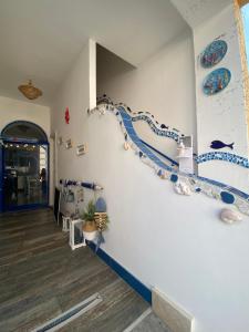 a hallway with blue and white walls with blue accents at Rosanna Maison in Ischia