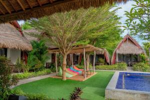 a resort with a hammock and a swimming pool at Krisna Bungalows and Restaurant in Sekotong