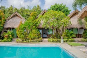 a villa with a swimming pool and a resort at Krisna Bungalows and Restaurant in Sekotong