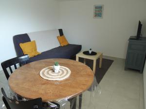 sala de estar con mesa y sofá en Appartement entre terre et baie, en Pontorson