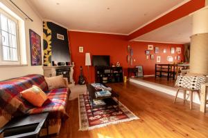 a living room with a couch and a table at Ahoy Surf House in Ferrel