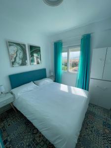 Säng eller sängar i ett rum på Apartamento edificio Goya