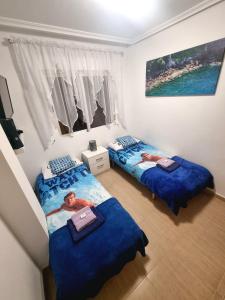 Giường trong phòng chung tại Spain Apartments Mar De Cristal