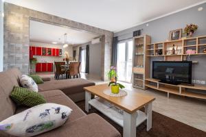 a living room with a couch and a tv at Apartment Thalia in Zadar