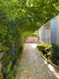 un arco con piante e un sentiero di pietra di Villa Savoia Mondello a Mondello
