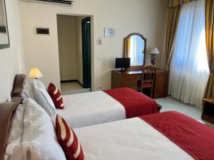 A bed or beds in a room at Albergo Italia