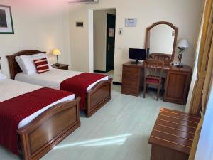 A bed or beds in a room at Albergo Italia