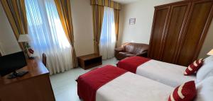 A bed or beds in a room at Albergo Italia