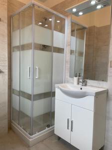 a bathroom with a sink and a shower at Casa Vacanze Mascali in Riposto +28 photos