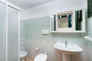 a white bathroom with a sink and a toilet at VILLA GAIA - Dall'alba al tramonto - in Torre delle Stelle +14 photos