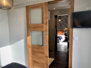 a sliding door with a television in a room at Hostellerie Bellevue in Rocamadour