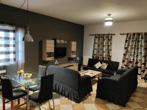 a living room with a couch and a table and chairs at Vretti's apartment in Kythira