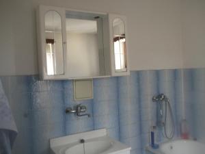 a bathroom with a sink and a mirror at Restaurace s ubytováním in Křižany
