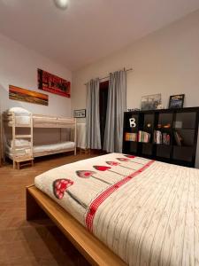 a bedroom with a bed and a book shelf at MARMORE HOUSE in Collestatte