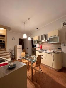 a kitchen with a table and a counter top at MARMORE HOUSE in Collestatte +16 photos