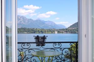 a balcony with a view of a lake and mountains at Royal Cadenabbia in Griante Cadenabbia