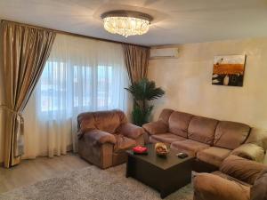 a living room with a couch and a table at Sunrise Home Apartment in Mangalia