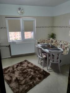 a living room with a table and chairs and a couch at Sunrise Home Apartment in Mangalia