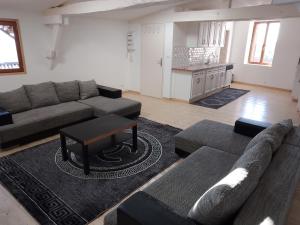 a living room with a couch and a table at Le Galion in Thiers