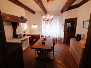 a kitchen and dining room with a table and a chandelier at 11 rue basse Najac in Najac