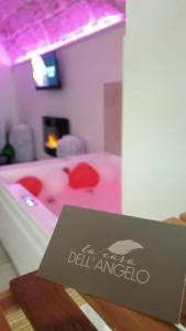 a sign in front of a pink bath tub at La casa dell'angelo in Monopoli