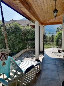 a porch with a swinging chair on a patio at BeBop Apartman in Kotor