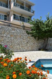 a building with a stone wall next to a swimming pool at Estate Dafnopanagia Villa Magda in Kariá