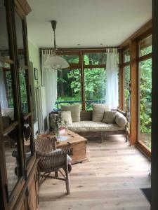 a living room with a couch and a table at Waldidyll in Neuzelle