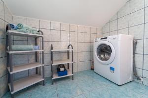 a laundry room with a washing machine in it at Apartment Nada in Petrcane