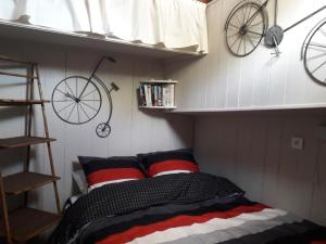 a small bedroom with a bed and a bike on the wall at Peniche Caroline in Capestang