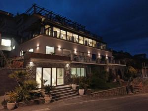 a large house with a balcony on top of it at Hotel Primavera Dell'Etna in Zafferana Etnea