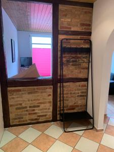 a room with a brick wall and a window at 1-Zimmer-Wohnung Astfeld in Langelsheim