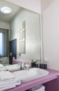 a bathroom with a sink and a large mirror at Bontempo Suite in Vasto