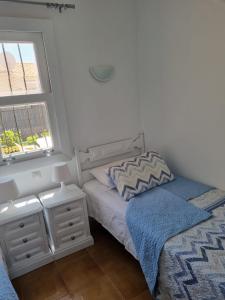 A bed or beds in a room at Bungalow Santa Fe de 2 habitaciones