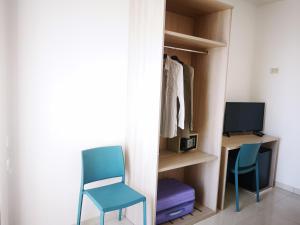 a room with two chairs and a desk with a monitor at Hotel Mare Blu in Torre dell'Orso