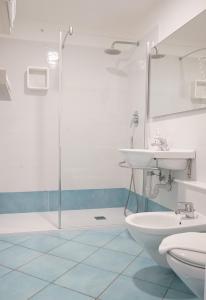 a bathroom with a shower and a sink and a toilet at Ancora Resort in Acciaroli