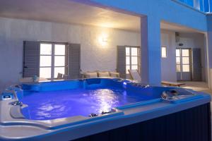 a large blue tub in the middle of a room at Sunset View Hotel in Parikia