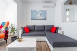 a living room with a couch and a sail boat at Apartment Ruzica in Dubrovnik