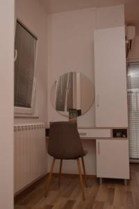 a desk with a chair and a mirror in a room at Villa Jankuloski in Ohrid +65 photos