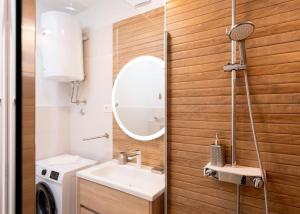 a bathroom with a sink and a washing machine at AWAKEN Gorgeous Sea View Apartment in Hvar +29 photos