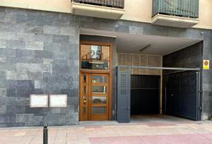 a building with a brown door and a balcony at Suite Anna in Zaragoza