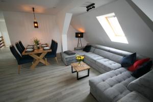 a living room with a couch and a table at Leśniczówka Grabczok in Grabczak