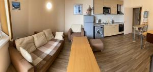 a living room with a couch and a table at First Line Apartment at Obzor in Obzor