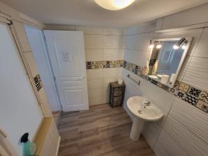 a small bathroom with a sink and a mirror at The Studio, in Saint-Rabier