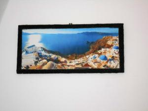 a framed picture of a beach in positano at The Three anchors Rooms Perissa in Perissa