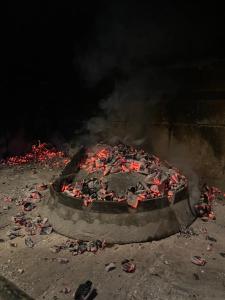 a pizza is cooking in an oven with smoke at Villa Enio in Bihać