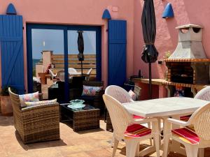 a dining room with a table and chairs and a patio at Casa Playa in Denia